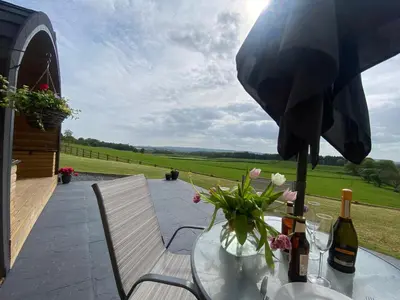 a table with a bottle of wine and a glass at Cleugh Lodge in Lockerbie