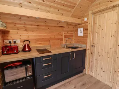 a kitchen with a counter and a sink in a cabin at Dryfe Lodge in Lockerbie