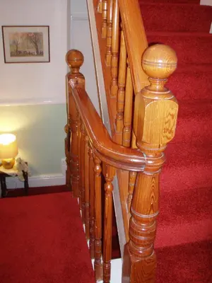 a wooden spiral staircase with a red carpet at Herdwick Guest House in Keswick