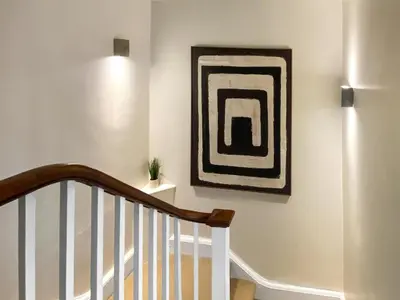 a hallway with a staircase with a painting on the wall at The Court House - Uk43908 in Silloth