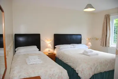 two beds sitting next to each other in a bedroom at Skiddaw Grove in Keswick
