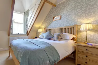 a bedroom with a large bed and a window at The Edwardene in Keswick