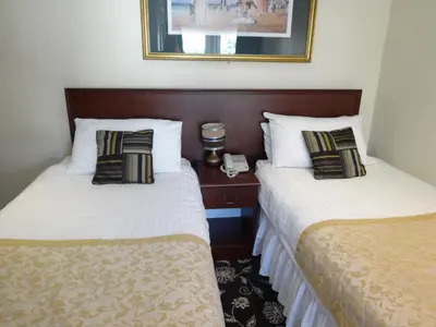 a hotel room with two beds and a telephone at Waverley Hotel in Workington