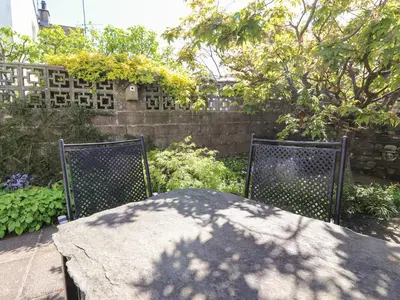 a table and two chairs in a garden at Primrose Cottage in Keswick