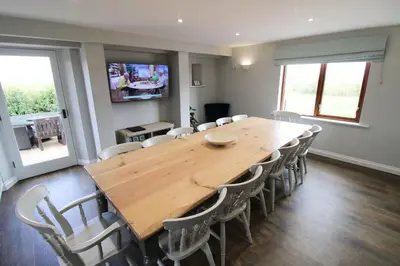 a conference room with a wooden table and chairs at Great Calva, Sebergham, perfect for 2 families or friends with 3 dogs welcome and hot tub in Sebergham