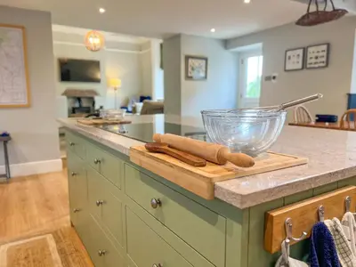 a kitchen counter with a cutting board and a bowl on it at High House, Southwaite in a rural setting with countryside views, garden with BBQ & hot tub in Southwaite