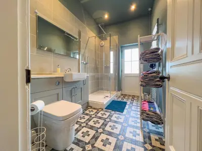 a bathroom with a toilet and a sink and a shower at High House, Southwaite in a rural setting with countryside views, garden with BBQ & hot tub in Southwaite