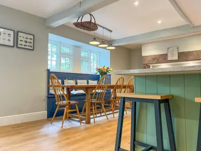 a dining room with a table and chairs at High House, Southwaite in a rural setting with countryside views, garden with BBQ & hot tub in Southwaite
