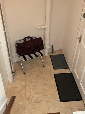 a hallway with a bag sitting on a bench in a room at Little Limetree in Moffat