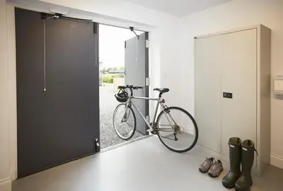 a bike parked in a room next to a door at Netherwood Lodge in Dumfries