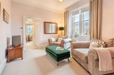 a living room with two couches and a tv at Cameron Fell Apartment Keswick at The Lairbeck in Keswick