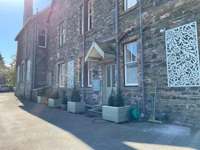 a brick building with potted plants outside of it at The Capsule Room at The Lairbeck in Keswick in Keswick