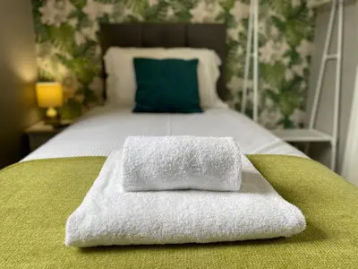 a bed with two towels sitting on top of it at The Capsule Room at The Lairbeck in Keswick in Keswick