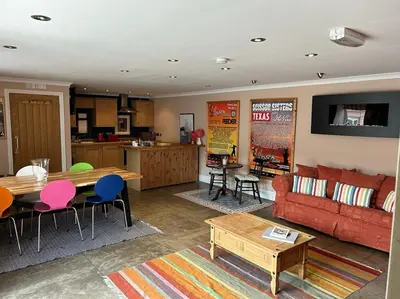 a living room with a couch and a table at The Wickerman Granary in Kirkcudbright