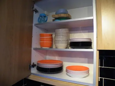 a pantry with plates and bowls on shelves at Family Home Near City Centre - New KING bed! in Carlisle