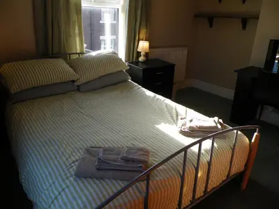 a bedroom with a bed with two towels on it at Family Home Near City Centre - New KING bed! in Carlisle