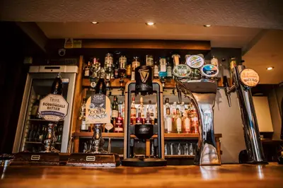 a bar with a lot of bottles of alcohol at Allerdale Court Hotel in Cockermouth