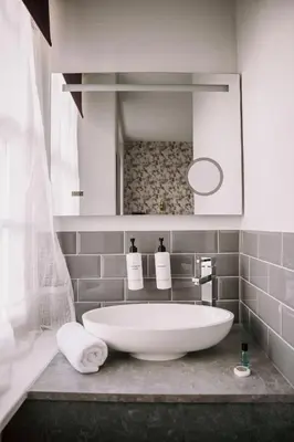 a bathroom with a large white bath tub on a counter at Allerdale Court Hotel in Cockermouth