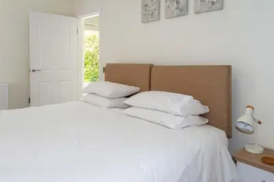 a bedroom with a white bed with white pillows at Skerrow in New Galloway