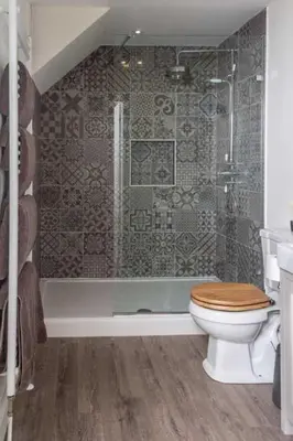 a bathroom with a shower and a toilet and a tub at Stroan in New Galloway