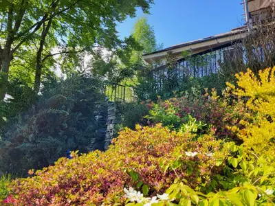 a garden with colorful flowers and a fence at Lingmoor Cottage in Chapel Stile
