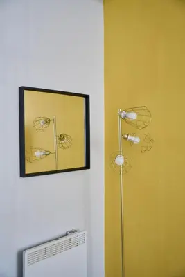 a mirror on a wall next to a radiator at 1 BDR Apt By Caledonia Luxe Stays Short Lets & Serviced Accommodation Lanark in Douglas