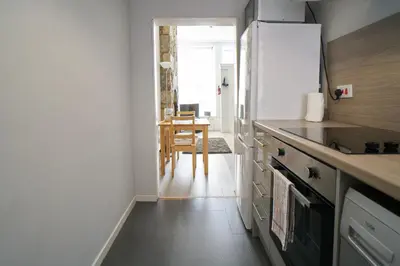 a kitchen with a counter and a table in it at 1 BDR House By Caledonia Luxe Stays Short Lets & Serviced Accommodation Lanark in Douglas