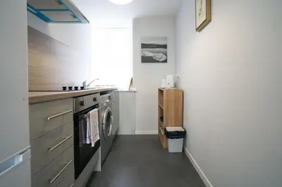 a kitchen with a sink and a stove at 1 BDR House By Caledonia Luxe Stays Short Lets & Serviced Accommodation Lanark in Douglas