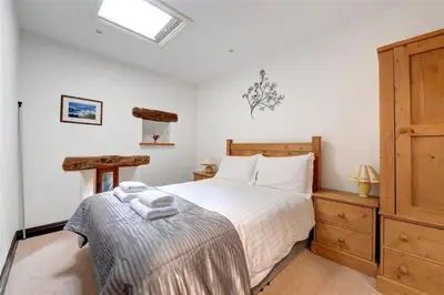 a bedroom with a bed and a wooden dresser at 2 Bed in Grasmere oc-gl007 in Grasmere