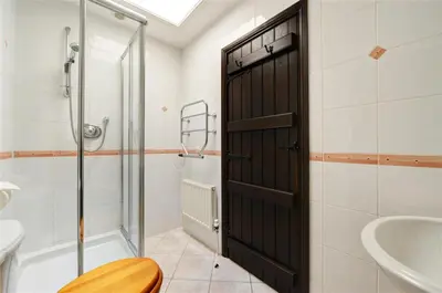 a bathroom with a shower and a black door at 2 Bed in Grasmere oc-gl007 in Grasmere