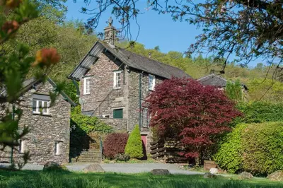an old stone house with a tower on top of it at 5 Bed in Grasmere oc-gl008 in Grasmere