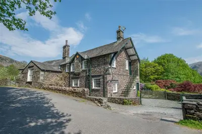 an old stone house on the side of a road at 5 Bed in Grasmere oc-gl008 in Grasmere