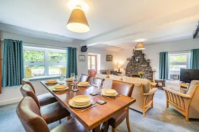 a dining room and living room with a table and chairs at 3 Bed in Elterwater oc-gl011 in Chapel Stile