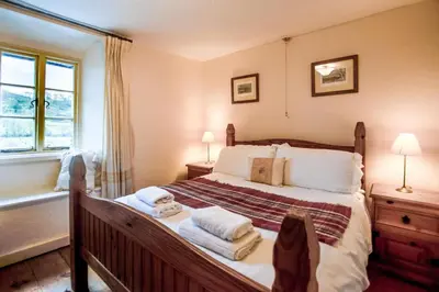 a bedroom with a large bed with towels on it at 3 Bed in Little Langdale oc-gl102 in Little Langdale