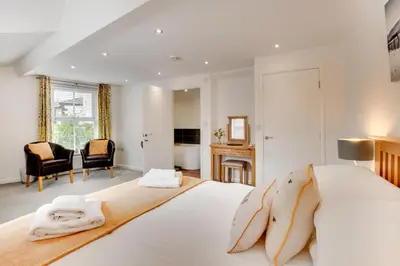 a bedroom with a large white bed with two towels at 2 Bed in Portinscale oc-gl129 in Portinscale