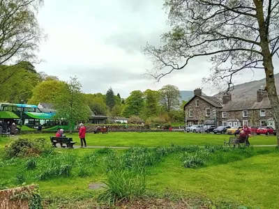 a group of people sitting on a bench in a park at 2 Bed in Grasmere oc-ld175 in Grasmere