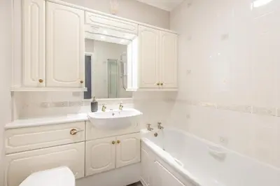 a white bathroom with a sink and a bath tub at 2 Bed in Grasmere oc-ld175 in Grasmere