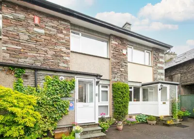 a brick house with white doors and ivy at 2 Bed in Grasmere oc-ld175 in Grasmere