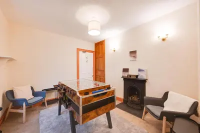 a room with a desk and chairs and a fireplace at 6 Bed in Keswick oc-ld177 in Keswick