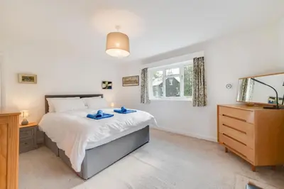 a bedroom with a bed and a dresser and a window at 3 Bed in Grasmere oc-ld181 in Grasmere