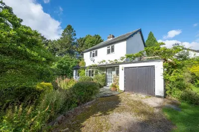 an exterior view of a white house with a garage at 3 Bed in Grasmere oc-ld181 in Grasmere