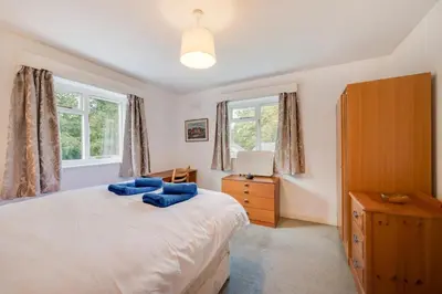 a bedroom with a bed with blue pillows on it at 3 Bed in Grasmere oc-ld181 in Grasmere