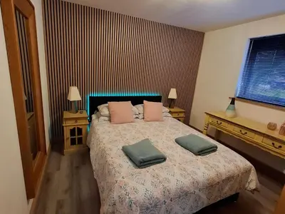 a bedroom with a bed with two pillows on it at Cairnyard Lodges - Woodside in Beeswing
