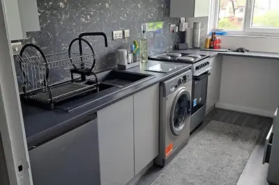 a kitchen with a sink and a washing machine at Apartment - Sleeps 4 - Pet friendly - Parking in Troon
