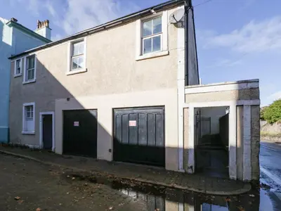 a house with two garage doors on a street at 8A Corkickle in Whitehaven