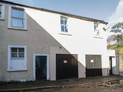 a white house with black doors and windows at 8A Corkickle in Whitehaven