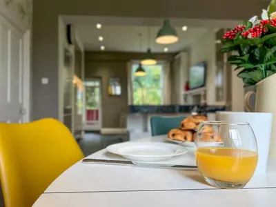 a glass of orange juice sitting on a table at Little Parrock, Grasmere nestled at the foot of Helm Crag with walks from the door in Grasmere