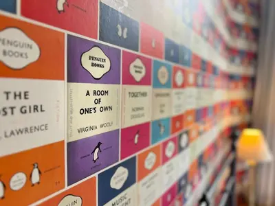 a wall filled with lots of stickers on a book shelf at Little Parrock, Grasmere nestled at the foot of Helm Crag with walks from the door in Grasmere