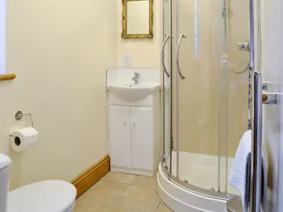 a bathroom with a shower and a sink and a toilet at Alby Bungalow in Wetheral