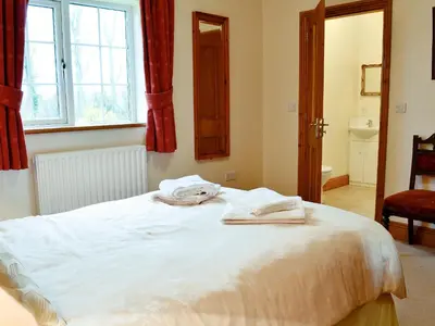 a bedroom with a bed with towels on it at Alby Bungalow in Wetheral